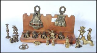 A collection of unusual brass ornamental figures to include mythical creatures, goblins, pixies