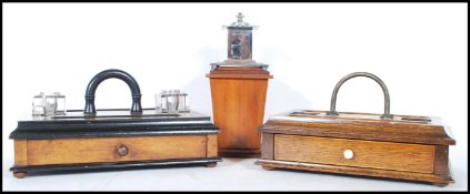 Two early 20th Century wooden desk top tidies / pen holders to include an oak tidy having two pen
