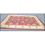 A large 20th Century contemporary floor rug on red