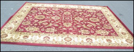 A large 20th Century contemporary floor rug on red