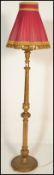 A 20th Century gesso gilt standard floor lamp, acanthus leaf terminus with reeded column upright