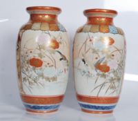 A pair of 19th Century polychrome and gilt  Japanese Kutani vases decorated with panels depicting