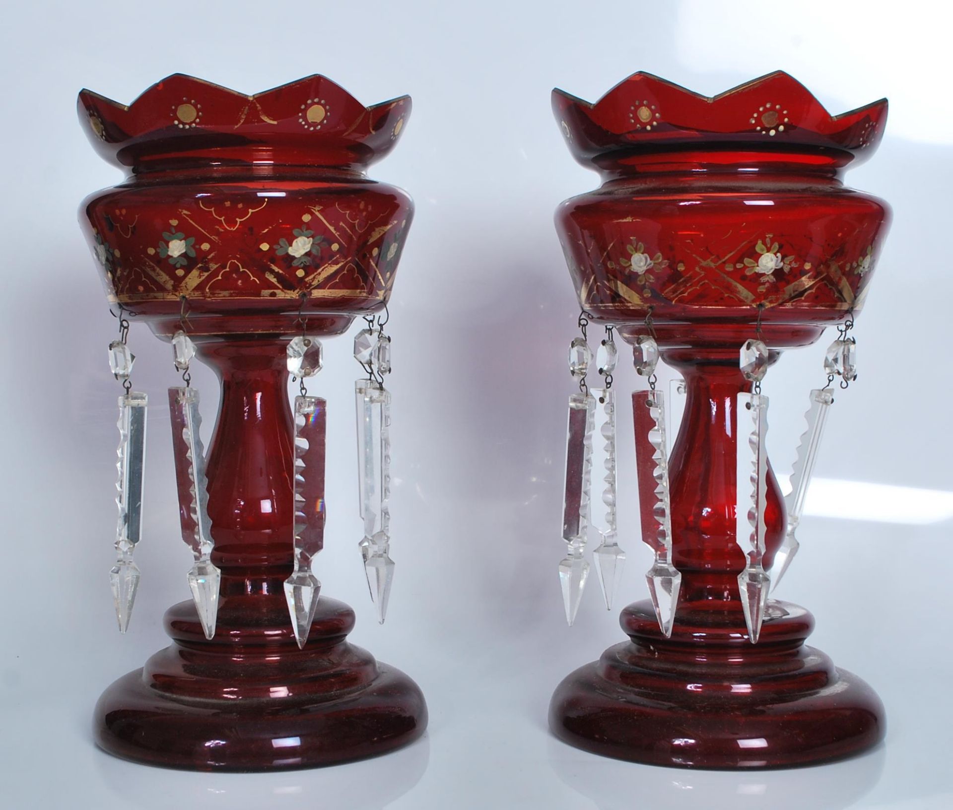 A pair of 19th Century Victorian ruby glass lustres, gilded decoration, on circular platform