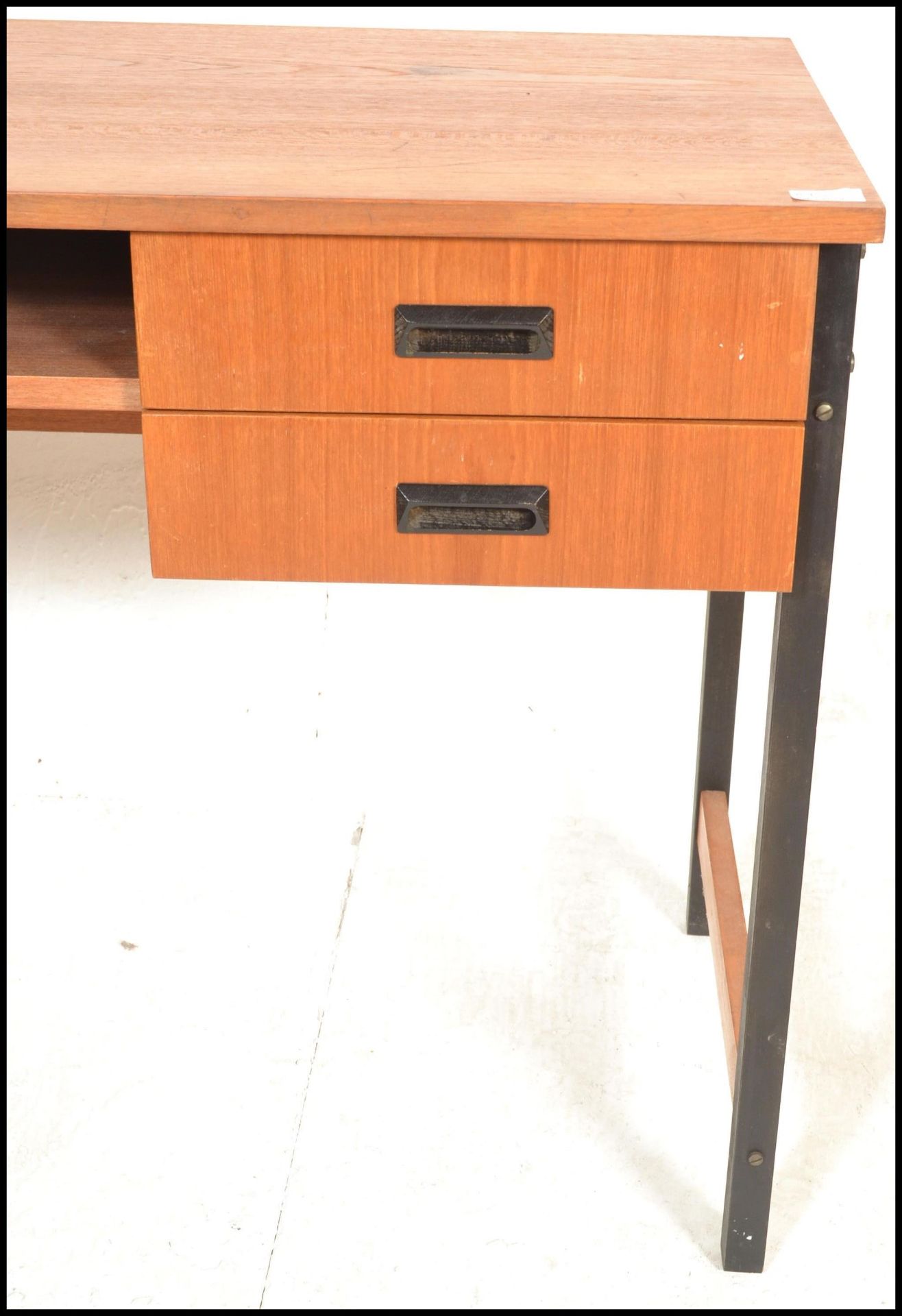 A 20th Century retro teak wood desk, raised on tubular black metal supports, two drawers to the - Bild 4 aus 6