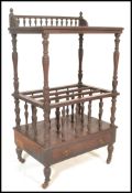 A 19th Century Victorian mahogany Canterbury having two tiers with a galleried top raised on