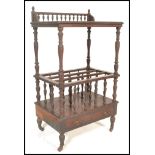 A 19th Century Victorian mahogany Canterbury having two tiers with a galleried top raised on