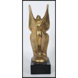 A 20th Century Art Deco style brass figure in the form of a lady wearing a butterfly wings style