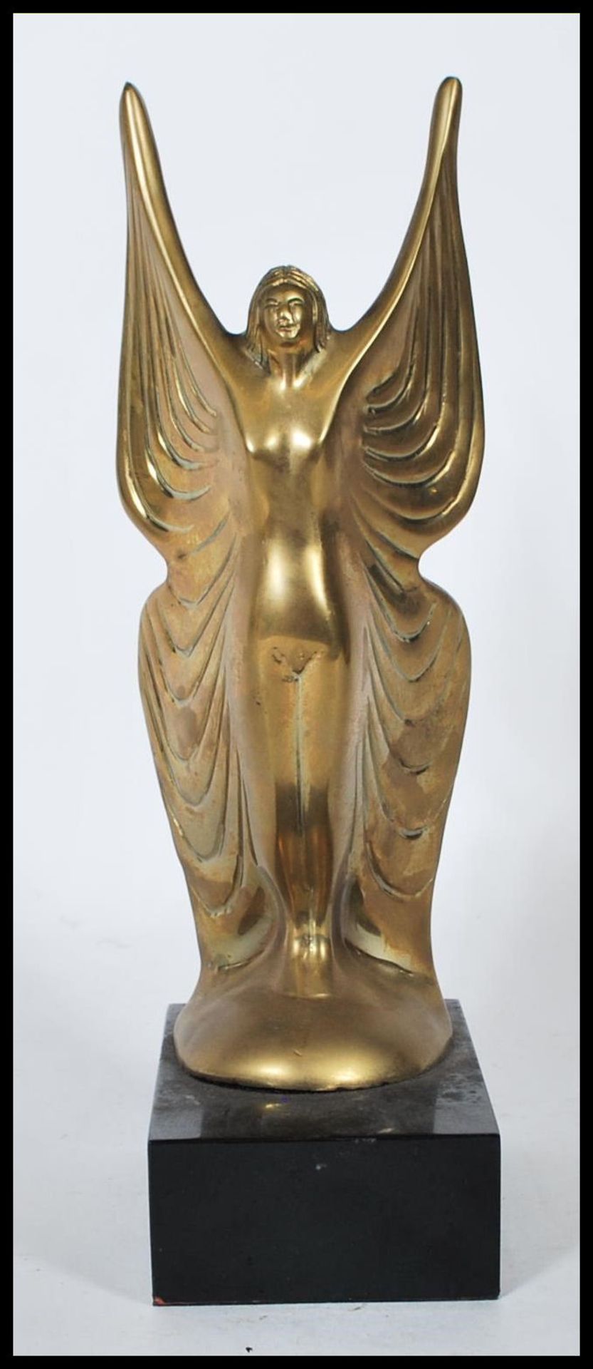 A 20th Century Art Deco style brass figure in the form of a lady wearing a butterfly wings style