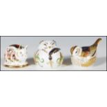 A group of three Crown Derby paperweights with gold stoppers to include a pig, a field mouse and a