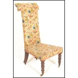 A 19th Century Victorian prie dieu / prayer chair upholstered in a floral tapestry material having
