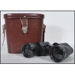 A pair of vintage Carl Zeiss Jena Jenoptem binoculars (10x50 W) in a brown leather case. Measures