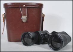 A pair of vintage Carl Zeiss Jena Jenoptem binoculars (10x50 W) in a brown leather case. Measures