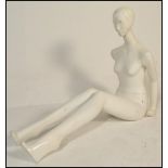 A vintage 20th Century shop display female mannequin having metamorphic posable limbs, with original