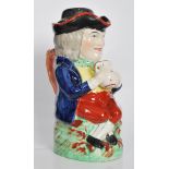 A early 19th Century Staffordshire lidded Toby fillpot jug, the gentleman being dressed in a