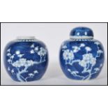 Two Chinese blue and white ginger jars being hand painted the the prunus pattern, of bulbous form,