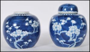 Two Chinese blue and white ginger jars being hand painted the the prunus pattern, of bulbous form,