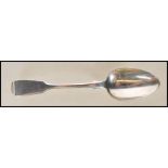 An English hallmarked Victorian silver spoon in the fiddle pattern, hallmarked London 1860, makers