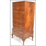 A 20th Century Art Deco Queen Anne bow front walnut tallboy chest of drawers being raised on