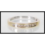 An English hallmarked 18ct gold ring channel set with square cut diamonds. Assay marked for
