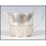 A late 19th Century silver hallmarked creamer / milk jug of small proportions having gadrooned