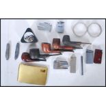 A collection of vintage 20th Century smoking pipes and paraphernalia to include Briar pipes by