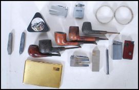 A collection of vintage 20th Century smoking pipes and paraphernalia to include Briar pipes by