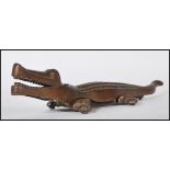 A vintage mid 20th Century cast brass nutcracker in the form of a crocodile, with metamorphic