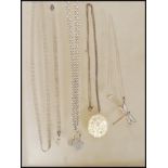 A small group of silver necklace chains and pendants to include a fine link chain having a dragonfly