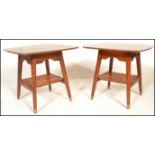 A pair of vintage 20th century 1970's coffee tables having square table tops with splayed tapering