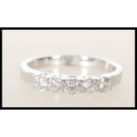 A hallmarked 18ct white gold five stone diamond ring of approx 35pts. Hallmarked 750 London. Ring