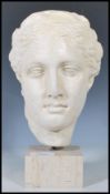 A 20th Century sculptural bust of composite form being of a classical greek female being raised on a