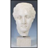 A 20th Century sculptural bust of composite form being of a classical greek female being raised on a