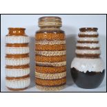 A group of three retro 20th Century West German fat lava vases / stick stands of various heights,