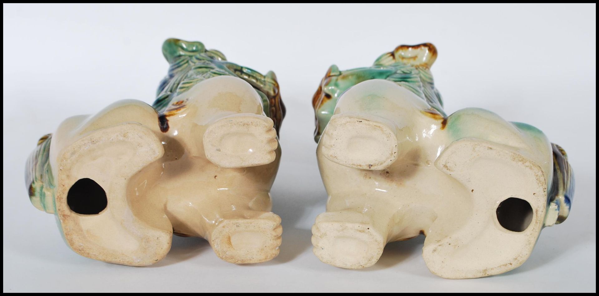 A pair of mid 20th Century Chinese porcelain temple lions / dogs of  Fu. Both modeled with a jade - Image 6 of 6
