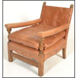 A good early 20th century leather upholstered easy armchair. The show wood frame raised on squared