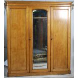 A 19th century Victorian ash triple wardrobe linen press compactum. Raised on a plinth base with a