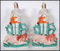 A pair of large 19th Century Staffordshire flat back figurines depicting Scottish hunters standing