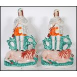 A pair of large 19th Century Staffordshire flat back figurines depicting Scottish hunters standing