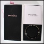 A stamped 925 silver Pandora charm bracelet bangle. The circular bangle having Pandora clasp with