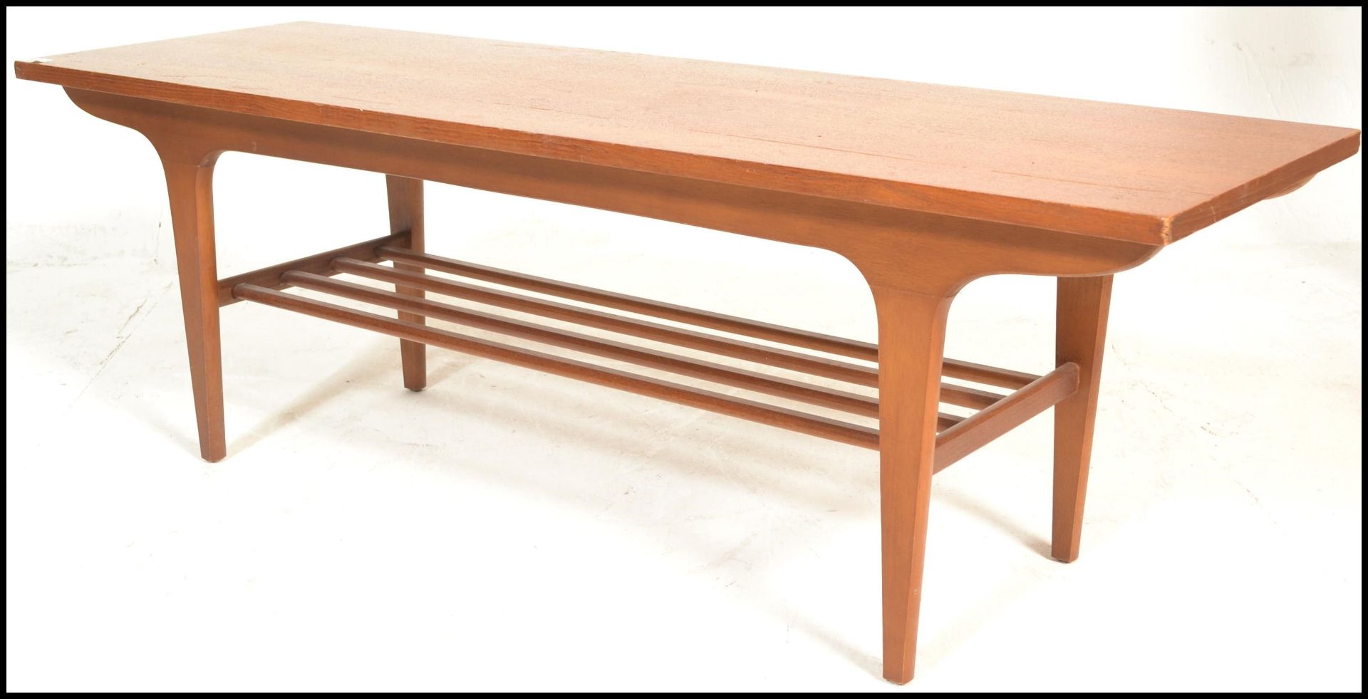 A mid century Danish influence teak wood long john coffee table being raised on tapering legs with a - Image 4 of 8