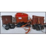 Three pairs of vintage 20th Century cased binoculars to include a leather cased military style pair,