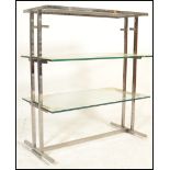 A vintage 20th Century vintage industrial glass and chrome shelving unit having two tiers of glass