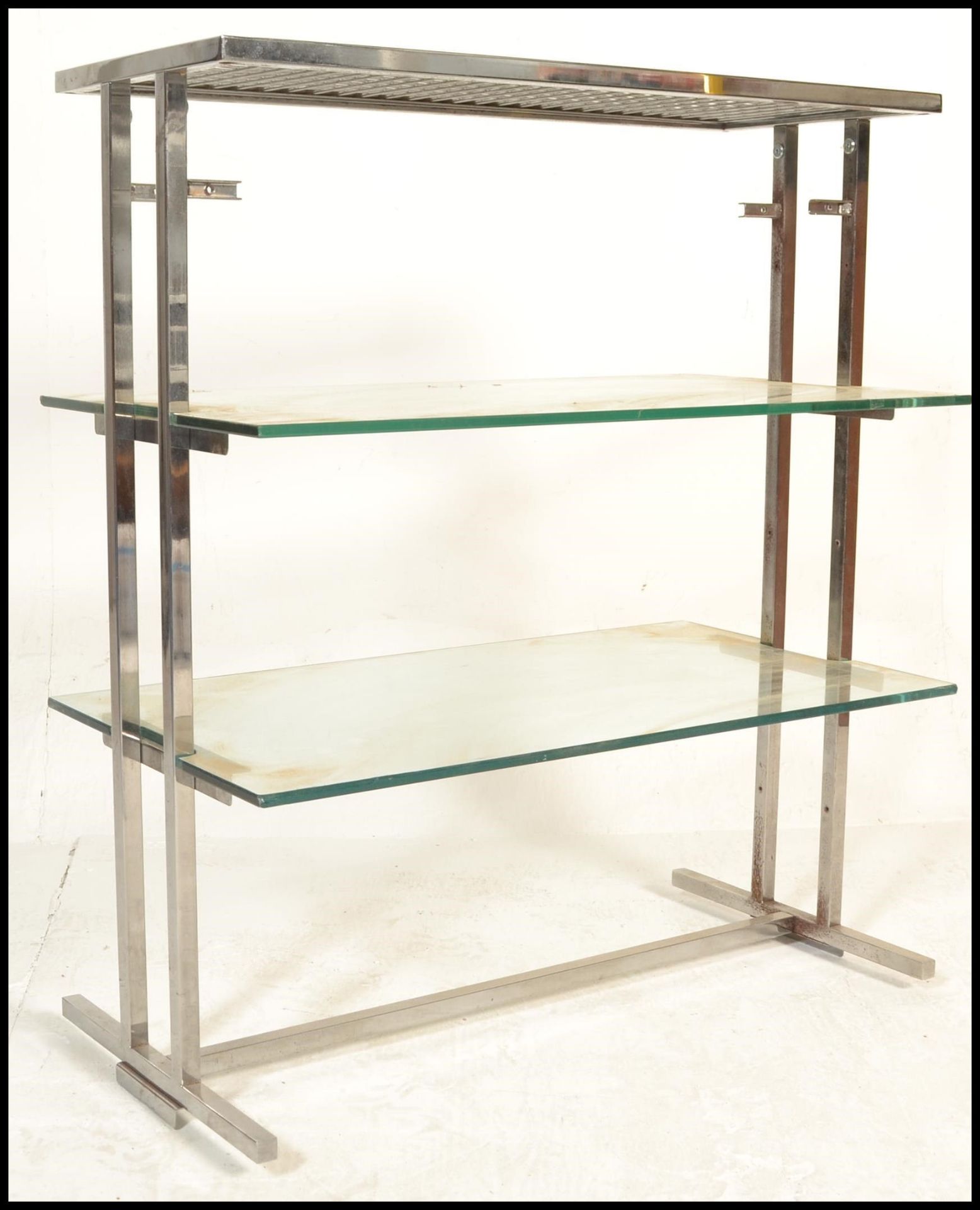 A vintage 20th Century vintage industrial glass and chrome shelving unit having two tiers of glass