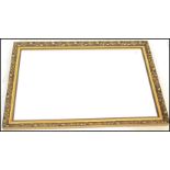 A 20th Century large overmantle framed wall mirror, the ornate gilt Art Nouveau style decorated in