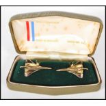 A pair of gold tone gentleman's cufflinks in the from of Concorde displayed in their original