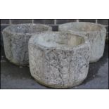 A collection of three well weathered octagonal reconstituted garden planters, each side moulded in