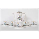 A vintage 20th Century Tuscun coffee service having a white ground with floral sprays and gilt