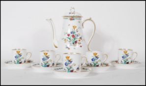 A vintage 20th Century Tuscun coffee service having a white ground with floral sprays and gilt