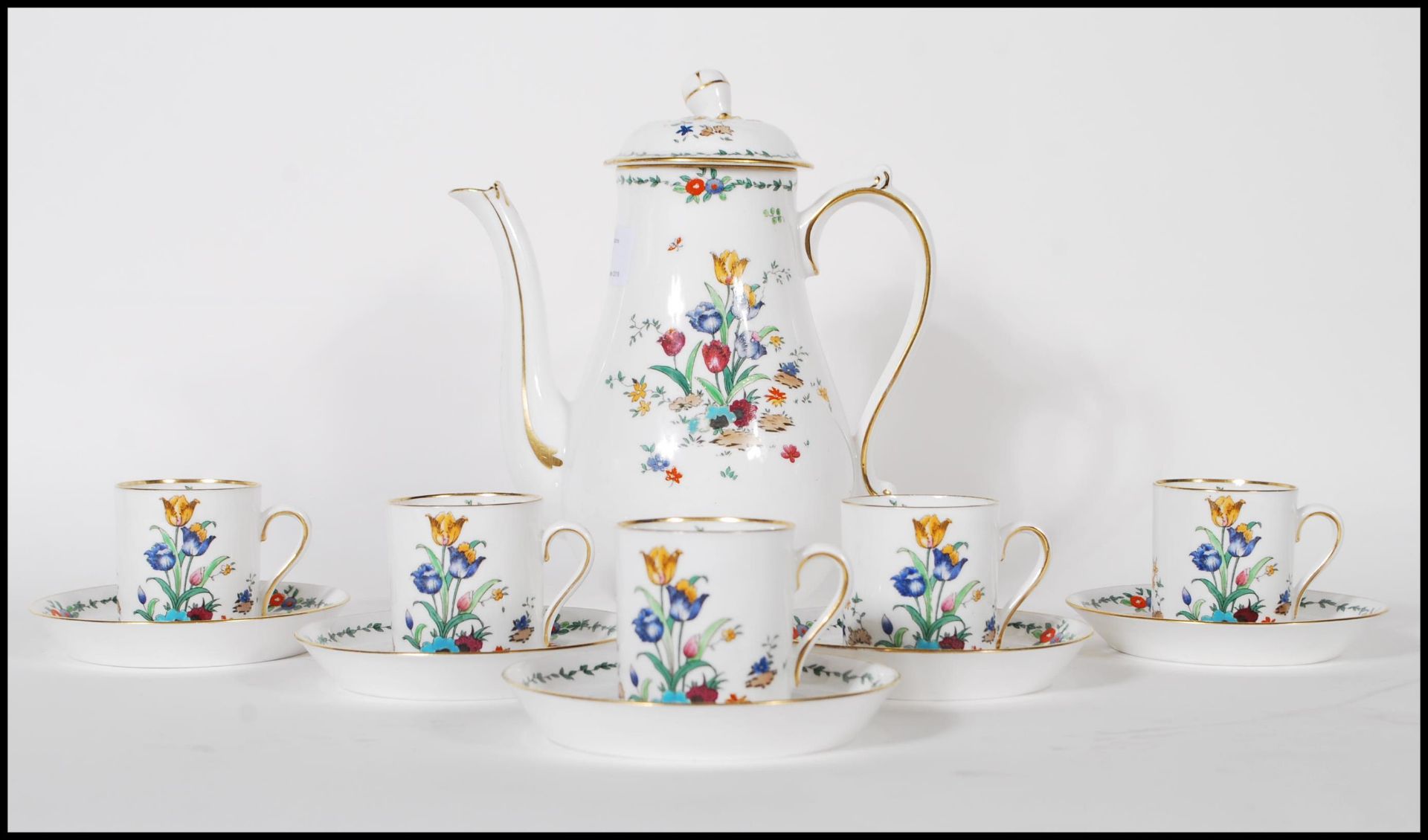 A vintage 20th Century Tuscun coffee service having a white ground with floral sprays and gilt