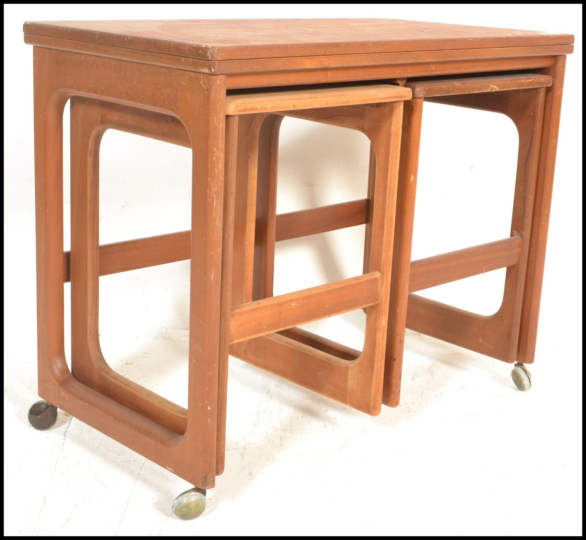 A vintage mid 20th Century McIntosh teak wood nest of tables with folding occasional top and 2 small